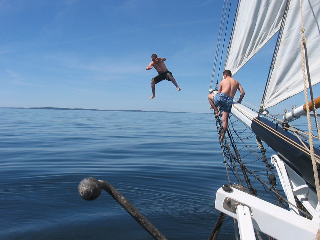 Guest jumps off the bow of the Maine Schooner Lewis R French