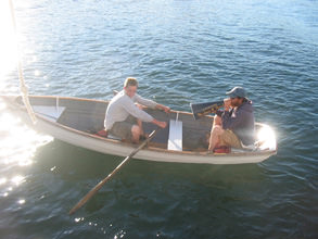 Garth patiently teach a crew member to row